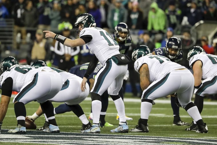 Eagles quarterback Carson Wentz points at the line against Seattle Seahawks on Sunday, December 3, 2017 at CenturyLink Field in Seattle. YONG KIM / Staff Photographer