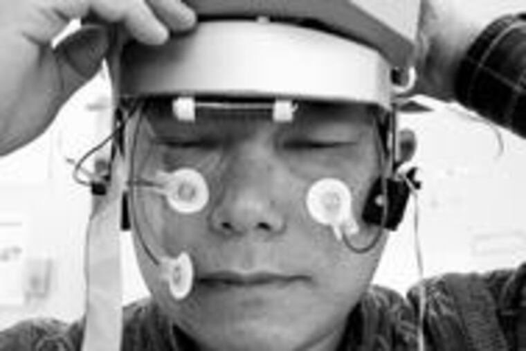 NeuroSky cofounder Koo Hyoung Lee tries out an early-model headset.