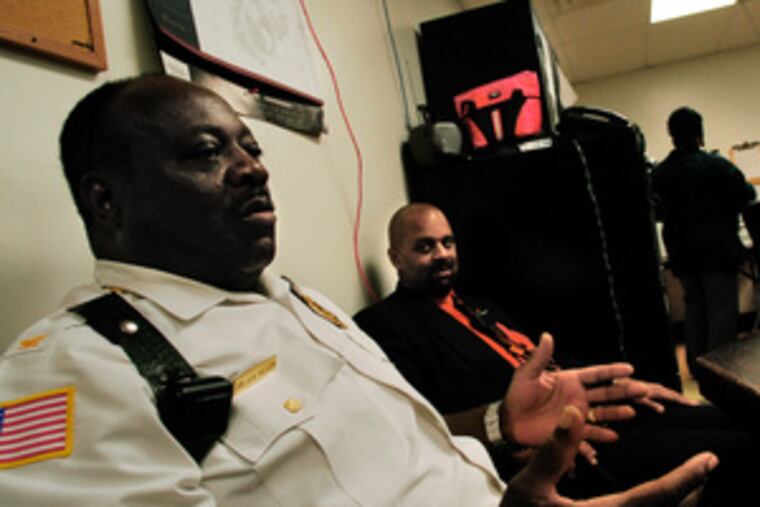 James H. Allen (left), Chester High's chief safety executive,talks about the school's security with the principal at his side. The shooting on Tuesday followed a fight, Allen said.