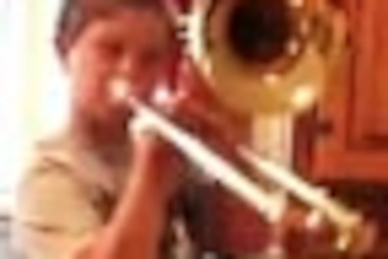 Aidan Milligan playing his trombone (it was stolen). He is shown in a video frame capture. His trombone was stolen Thursday but Phila. Orchestra is giving him a new one.