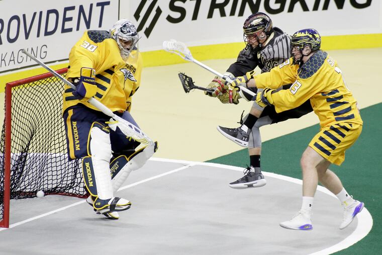 Swarm goalie Mike Poulin missed the shot, but this goal by the Wings' Chris Cloutier (middle) was challenged and not allowed in the first quarter on Jan. 12. The Wings will return to action Saturday.