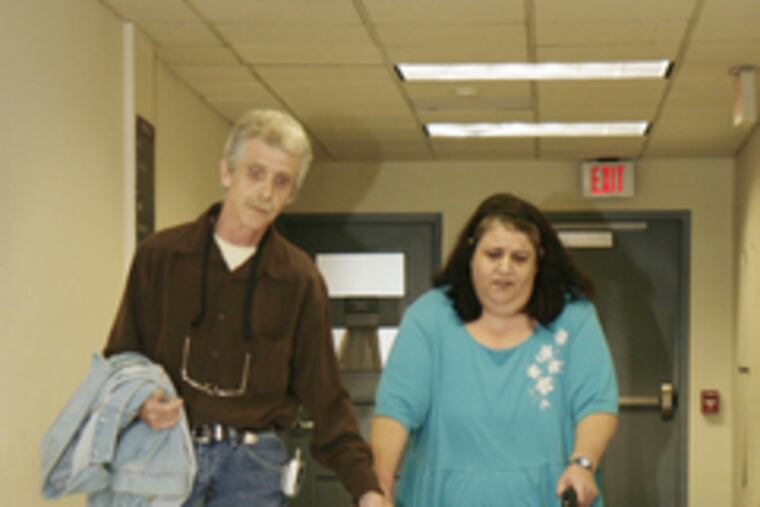 Dillon Cossey (left) enters the the courthouse in Norristown yesterday, just after his father and mother (above).