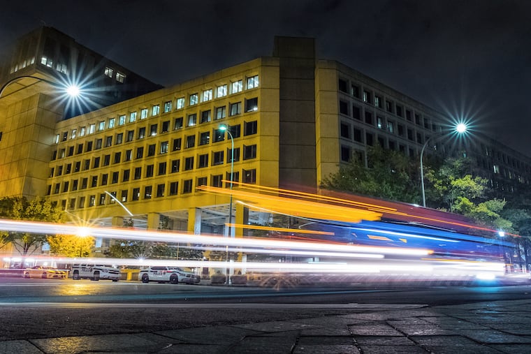 Traffic along Pennsylvania Avenue in Washington streaks past the Federal Bureau of Investigation headquarters building.