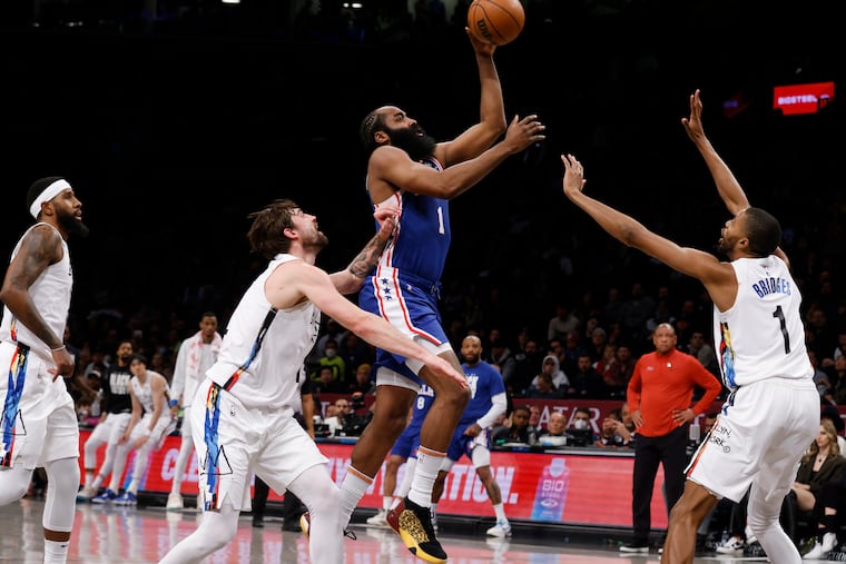 James Harden of the Sixers goes up for a shot against his former team, the Brooklyn Nets.