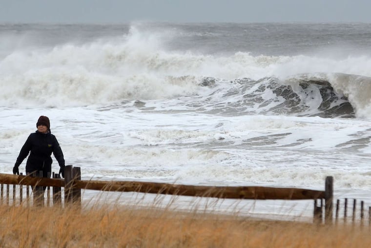 Agnes Love, 78, a retired teacher who winters in Ocean City walks the dunes as nor'easter generated waves pound the beach. Yesterday was "just wonderful," she said. "No precipitation, and the temperature is great. What more could you want?"
