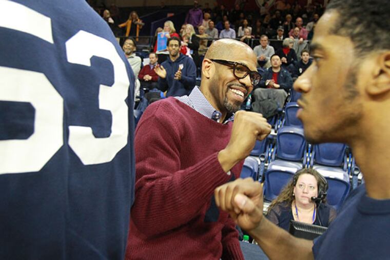 Penn head coach Jerome Allen pounds fists with his players prior to their game against Princeton on March 10, 2015. (Charles Fox/Staff Photographer)