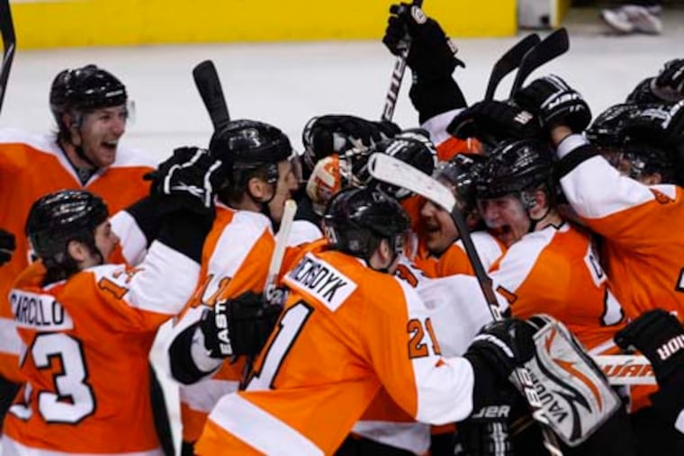 The Flyers celebrate with goalie Brian Boucher at the end of their dramatic 2-1 shootout win over the New York Rangers on April 11, 2010 at the Wachovia Center.