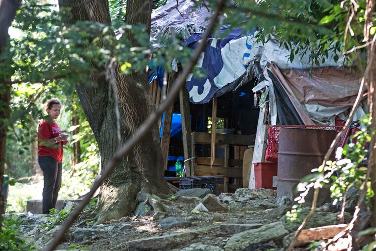 A homeless advocate beside a makeshift shelter under the 2nd St. bridge at Indiana in Philadelphia. This encampment used by homeless and alleged drug users is being cleared of residents for cleanup by the city of Philadelphia and Conrail.