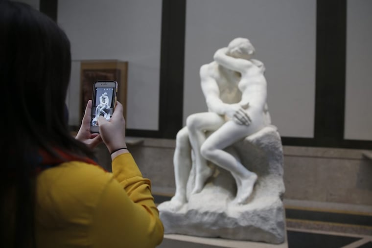An unidentified woman photographs a copy of Rodin’s “The Kiss” at the Rodin Museum. The museum unveiled a new exhibition around the theme of passionate embrace early in 2017. DAVID MAIALETTI / Staff Photographer