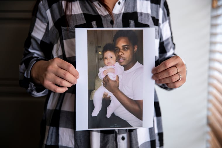 Elyse Tesno holds a photo of her boyfriend, Terrence Taylor, with their 5-year-old daughter Serenity. Taylor, 23, died of heart failure in the Montgomery County jail in 2017, and his family is now suing the county, saying they failed to provide him proper care.