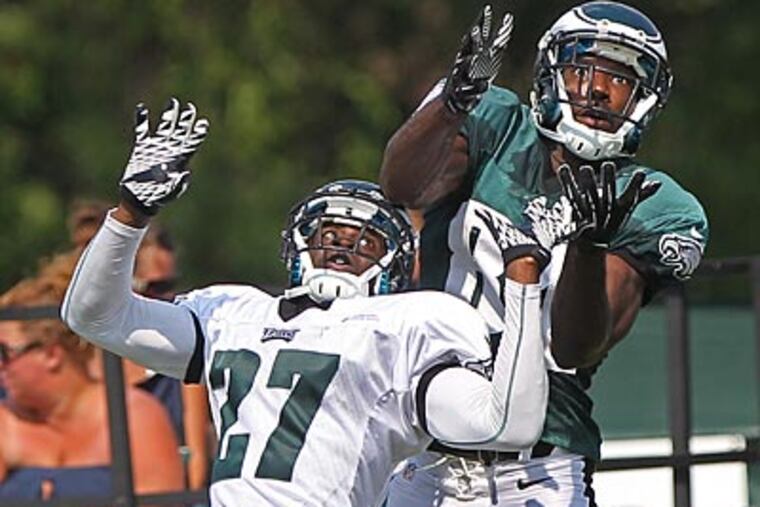 Eagles cornerback Brandon Hughes defends receiver Jason Avant during training camp. (Michael Bryant/Staff Photographer)