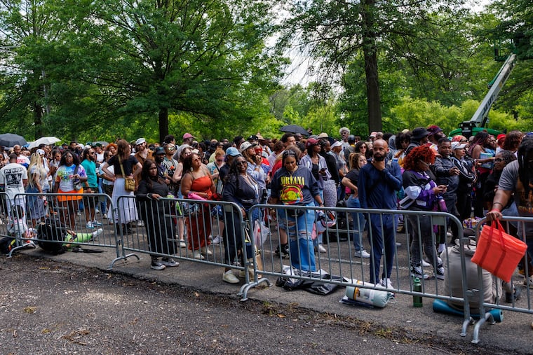 People wait in line for the gates to open hours after the scheduled opening on the first day of the Roots Picnic on Saturday.