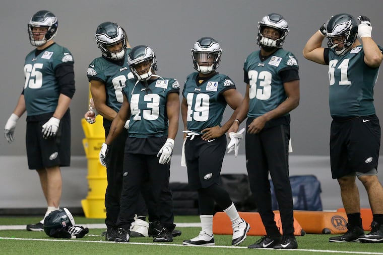 Eagles running backs Darren Sproles (43) and Boston Scott (49) warm up prior to Thursday's practice at the NovaCare Complex.