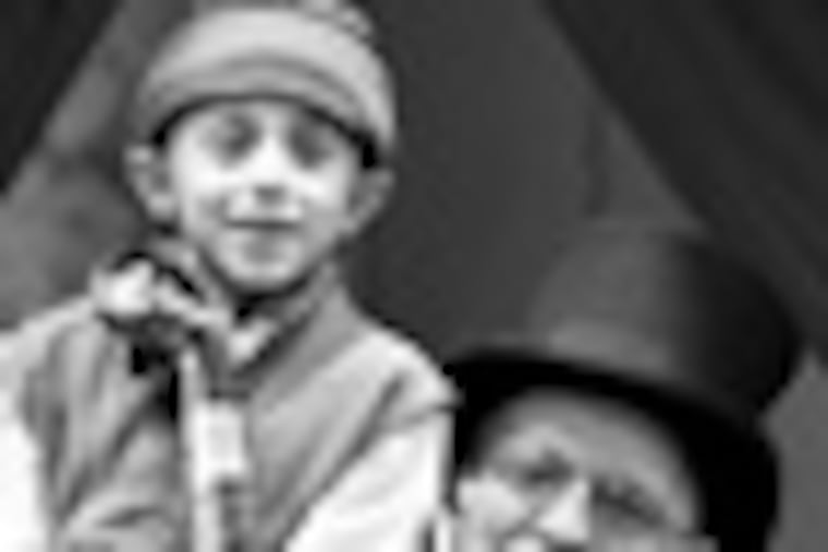 Joseph Mancini (Tiny Tim) and Benjamin Lovell (Scrooge) in Walnut Street Theatre for Kids’ production of Charles Dickens’ A Christmas Carol. Photo by Mark Garvin.