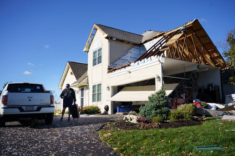 Dave Shank puts a suitcase into his car as he prepares to leave his damaged home in Thornbury Township on Nov. 1, 2019, after an EF-2 tornado ripped through the Delaware County town.