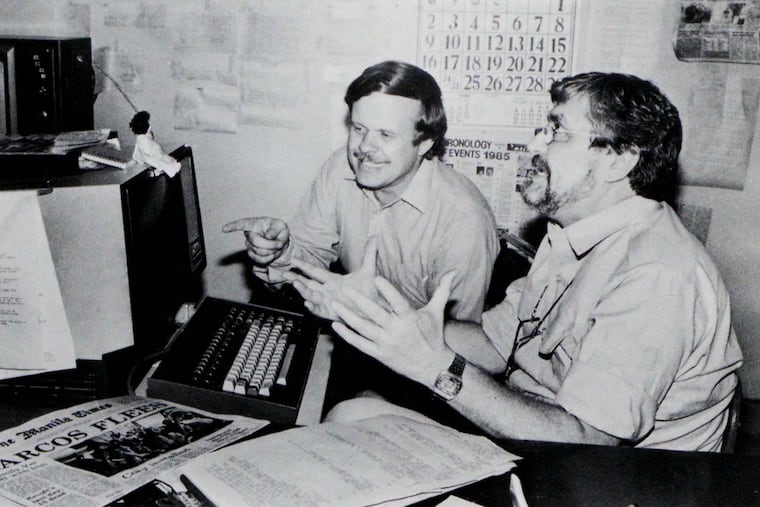 In this undated photo published in The AP World in 1986, Manila bureau chief David Briscoe (left) and Asia news director Richard Pyle discuss a story.