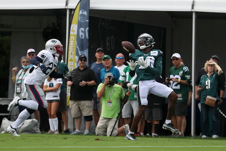 Eagles wide receiver Quez Watkins (right) makes a catch during a joint practice with the Patriots on Monday.