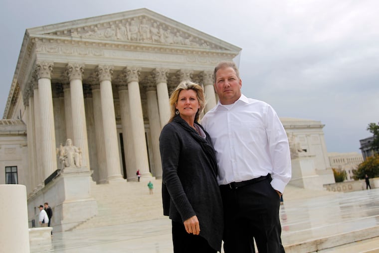Michael and Chantell Sackett of Priest Lake, Idaho, pose for a photo in front of the Supreme Court in Washington in 2011.