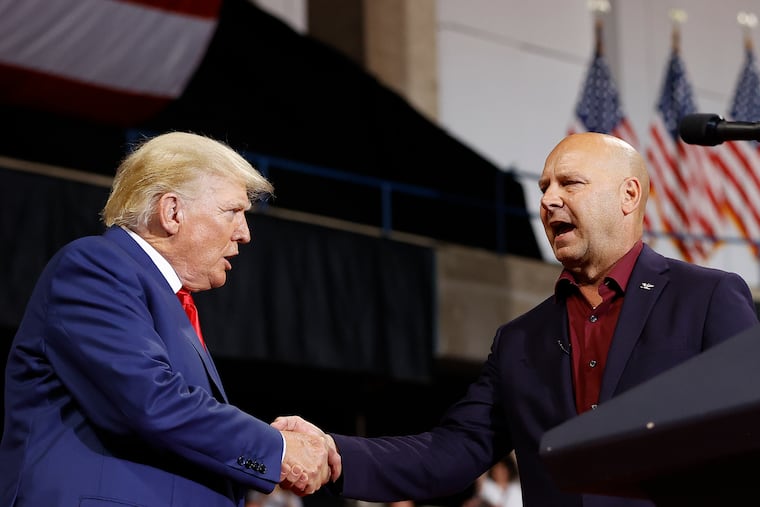 Former President Donald Trump shaking hands with State Sen. Doug Mastriano (right) during a Wilkes-Barre rally in September.