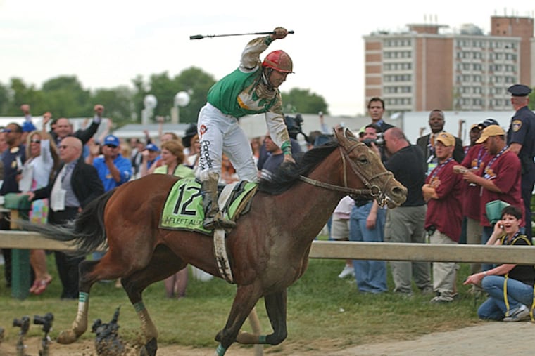 Jeremy Rose rejoices as Afleet Alex crosses the finish line ahead of the field on May 20, 2005. (Joan Fairman Kanes/Inquirer File Photo)
