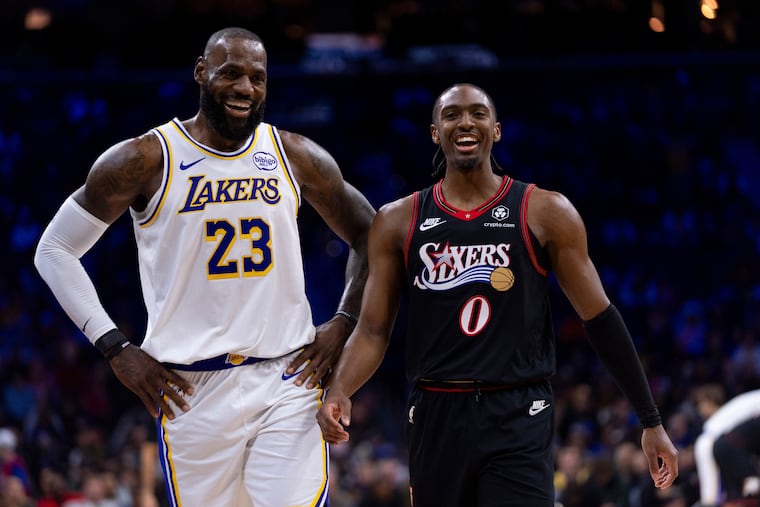 Los Angeles Lakers' LeBron James, left, shares a laugh with Philadelphia 76ers' Tyrese Maxey, right, during an NBA basketball game, Sunday, Dec. 7, 2025, in Philadelphia.