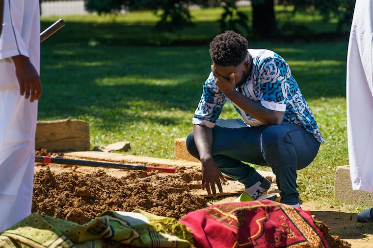 Simeon Koroma grieves for his friend Isiaka Meite during the funeral service at Friends South Western Burial Ground, in Upper Darby where friends, family, and community members gathered, June 21, 2019. Simeon said that Isiaka Meite was his best friend, they were close in high school and stayed close playing in a recreational soccer league. Meite was killed when a gunman opened fire on a graduation party he was attending, at Paschall Playground in Southwest Philadelphia.