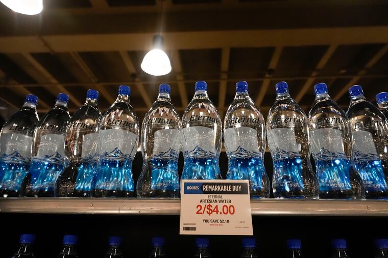 Bottled water in plastic bottles line the shelves at a grocery store in New Orleans, Wednesday, April 17, 2024. People are increasingly breathing, eatin,g and drinking tiny particles of plastic, however, there are simple things people can do at the grocery store if they want to use less plastic. (AP Photo/Gerald Herbert)