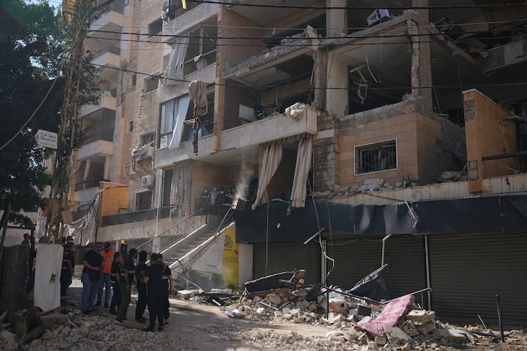 Lebanese security officers gather at the site where an Israeli airstrike hit a building in Dahiyeh, Beirut's southern suburb, Lebanon, Sunday, June 7, 2026.