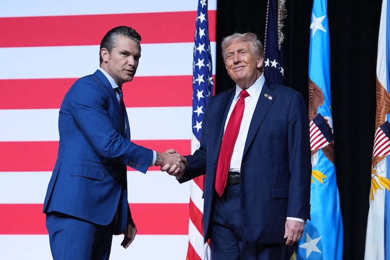 President Donald Trump is greeted by Secretary of Defense Pete Hegseth before speaking to a gathering of top U.S. military commanders at Marine Corps Base Quantico on Tuesday, Sept. 30.