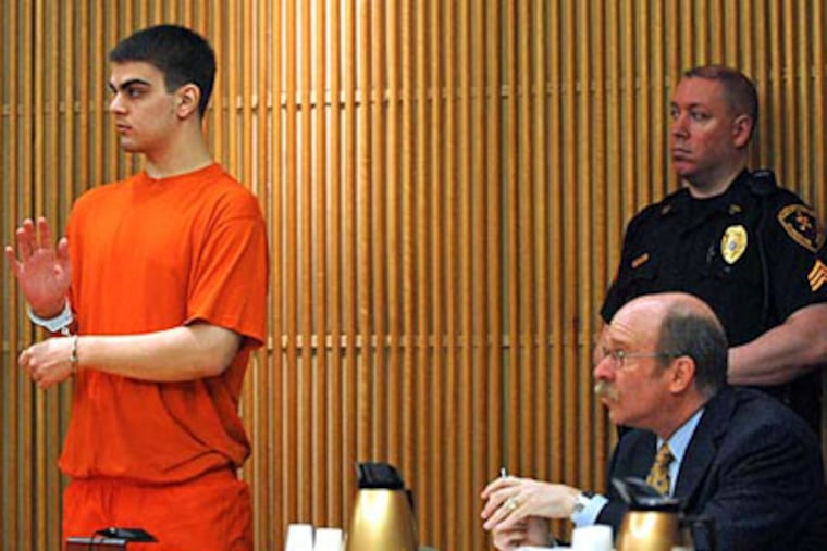 Jason Henry raises his hand-cuffed right hand to swear an oath as he is is sentenced in State Superior Court in Woodbury. (Tom Gralish / Staff Photographer)