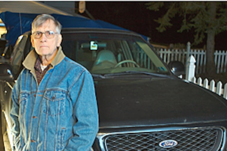 Ronald McDonagh next to his his Ford F150 parked outside his Doylestown home. Thieves stole cash from the unlocked pickup.( John Costello / Inquirer )