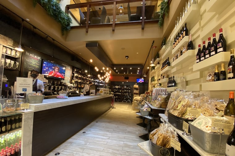 Tables at Gran Caffe L'Aquila have been removed in favor of shelves of groceries.