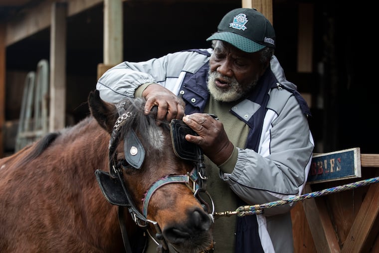 Founder Ellis Ferrell puts a bridle on Babbles before a get-out-the-vote ride out at the Fletcher Street Urban Riding Club stables in Philadelphia in 2020.