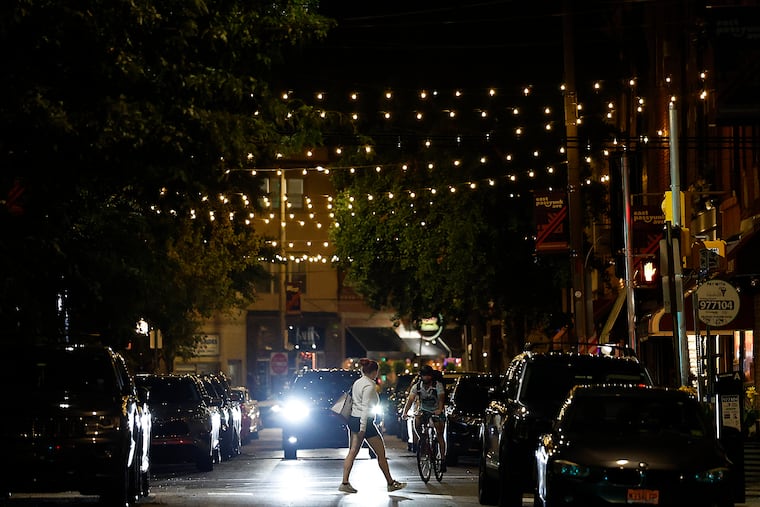 Lights string across the street along East Passyunk in South Philadelphia on Thursday.