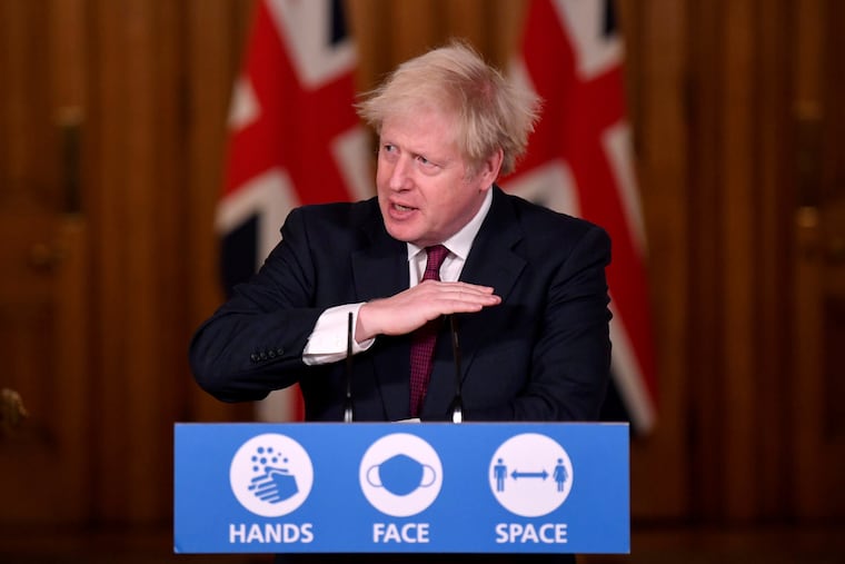 Britain's Prime Minister Boris Johnson speaks during a news conference in response to the ongoing situation with the coronavirus (COVID-19) pandemic, inside 10 Downing Street, London, Saturday, Dec. 19, 2020. Johnson says Christmas gatherings can’t go ahead and non-essential shops must close in London and much of southern England as he imposed a new, higher level of coronavirus restrictions to curb rapidly spreading infections.
