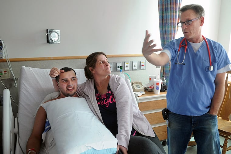 SARAH J. GLOVER / Staff Photographer
Cardiologist Gil Wernovsky talks with Jimmy Axten, 24, of Egg Harbor Township, and his mother, Marita, at Children’s Hospital. Axten is among the world’s earliest survivors of hypoplastic left heart syndrome. He benefited from groundbreaking surgery at the time. Caleb Reed, 4 months, recently had heart surgery.