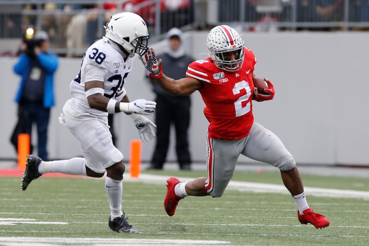 FILE - In this Nov. 23, 2019, file photo, Ohio State running back J.K. Dobbins, right, cuts up field against Penn State defensive back Lamont Wade during the first half of an NCAA college football game, in Columbus, Ohio.