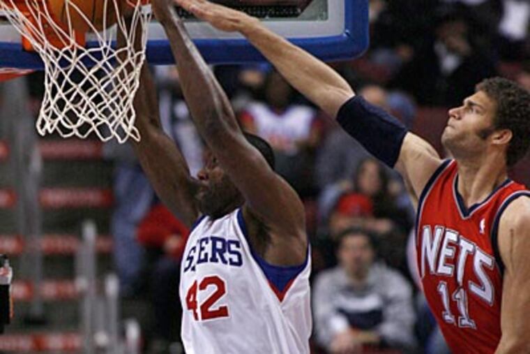 Nets center Brook Lopez is unable to block Elton Brand's dunk attempt. (H. Rumph Jr/AP Photo)