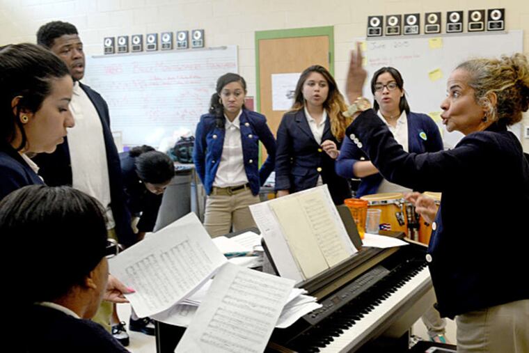 Suzzette Ortiz conducts rehearsal for her singers. She started teaching in Camden schools in 1986. TOM GRALISH / Staff Photographer