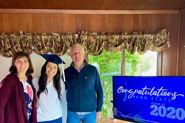 Penn State graduate Regina Duesler watches the school's virtual commencement at home with family.