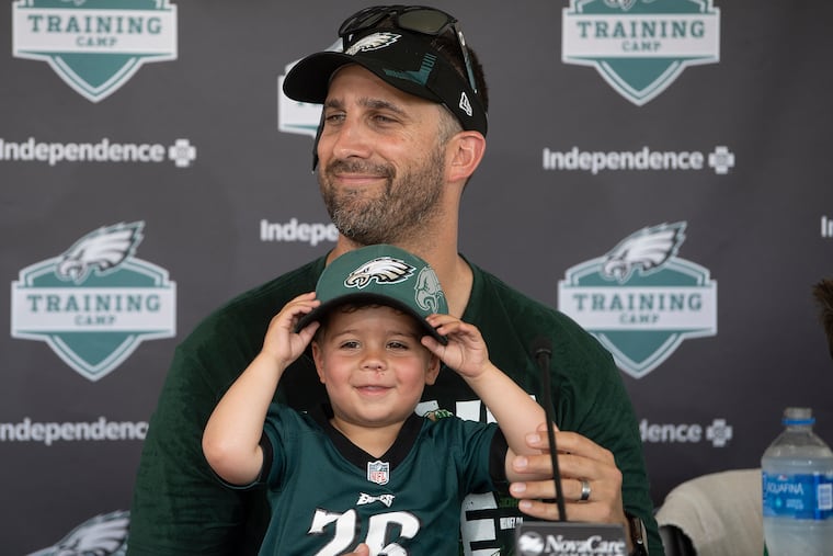 Eagles coach Nick Sirianni speaks to the media joined by his son Miles during training camp on Thursday.