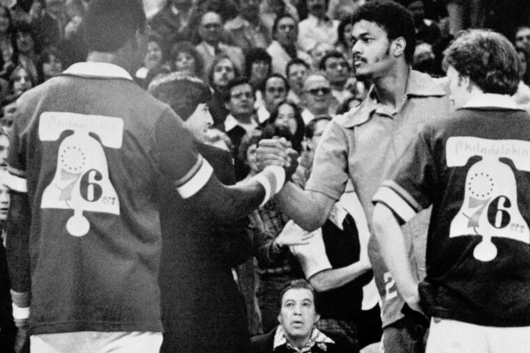 Maurice Lucas, right, of the Trail Blazers shakes hands with Darryl Dawkins of the 76ers prior to the start of Game 3 of the NBA Finals on May 29, 1977. Lucas and Dawkins were tossed out of Game 2 for fighting and were fined $2,500 each. (AP Photo)