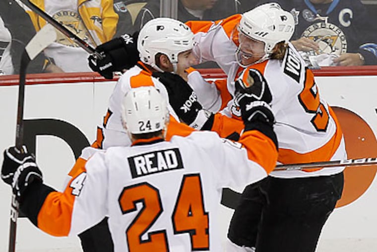 Jakub Voracek (right) celebrates with Matt Carle and Matt Read after scoring the game-winning goal. (Yong Kim/Staff Photographer)
