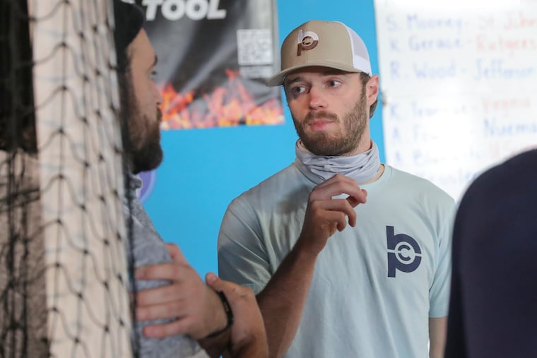Mike Adams (right), speaking with Padres pitcher Brett Kennedy, has a booming business as co-owner of the Baseball Performance Center in South Jersey and is a member of the Phillies' triple-A pitching staff in Lehigh Valley.