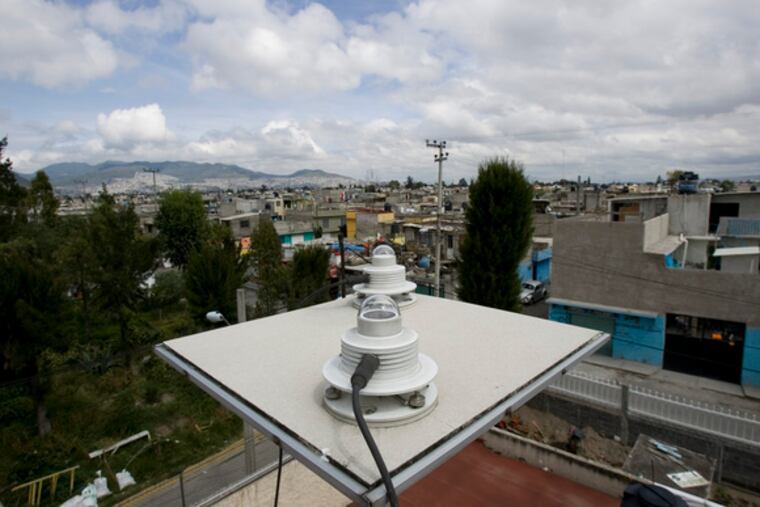 sits on a Mexico City rooftop. Efforts to reduce pollution intensified in the early 1990s.