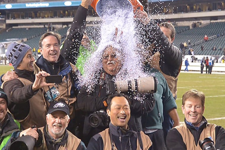 Retiring staff photographer Ron Cortes got a Gatorade bath from his colleagues after the Eagles' last home game. (Clem Murray/Staff Photographer)