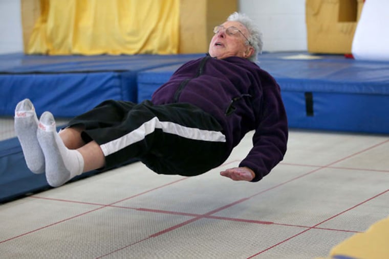 Elliott Royce takes trampoline lessons at Minnesota Twisters, Tuesday, Feb. 25, 2015 in Edina, Minn. Royce estimates that he has fallen down at least 14,000 times to teach people -- primarily seniors -- how to fall safely if they are undone by slippery sidewalks. (Elizabeth Flores/Minneapolis Star Tribune/TNS)