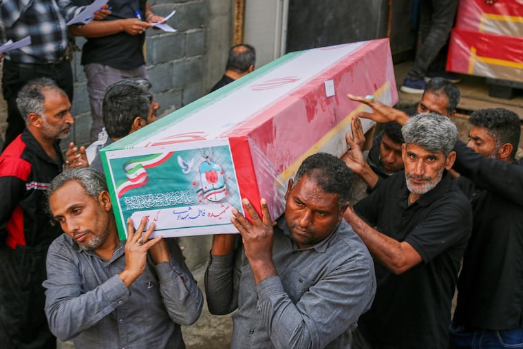 A coffin is carried Tuesday during the funeral of mostly children killed in what Iranian officials said was an Israeli-U.S. strike Feb. 28 at a girls' elementary school in Minab, Iran.