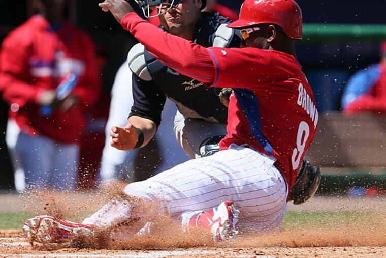 Domonic Brown slides into home against the Yankees on Thursday, March 13. (Yong Kim/Staff Photographer)