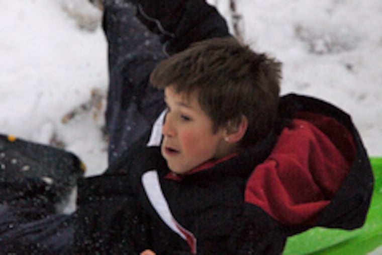 Trey Frieda's "flying saucer" stopped on a log but the 11-year-old tumbled into the snow yesterday in Blackwood.